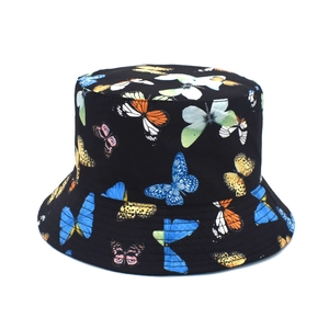 Detail of black reversible bucket hat with colorful butterfly print in high quality cotton