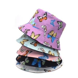 Detailed pile of five butterfly print bucket hats in purple, blue, pink, black and white