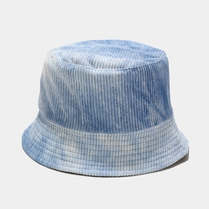 Detailed view of light blue tie-dye corduroy fabric texture on a wide brim bucket hat