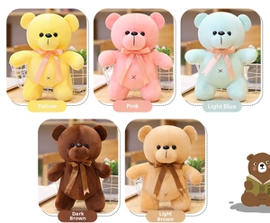 Detail of colorful teddy bears with ribbon bows and handmade X-stitch belly design