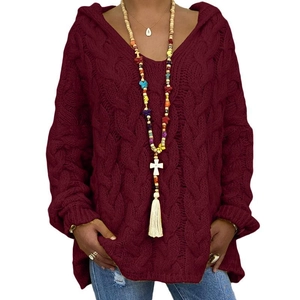 Detail of burgundy cable knit hoodie sweater with chunky texture and v-neckline