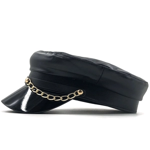 Detailed view of black PU leather military cap with a thick gold chain and smooth visor