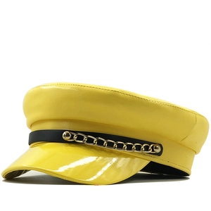 Bright yellow PU leather baker boy hat with gold metal chain and black trim detailing
