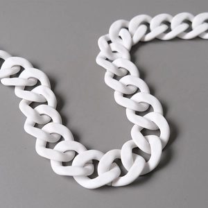 Macro shot of large matte white acrylic chain link with smooth resin finish for handbags