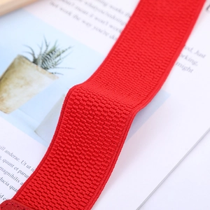 Macro shot of red elastic waistband with dense horizontal texture and high stretch