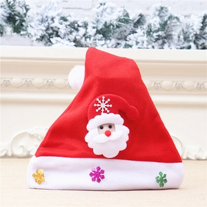 Detail of red felt Christmas hat with plush Santa Claus figure and sparkling snowflake sequins