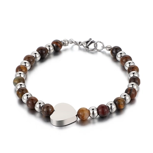 Tiger eye bead bracelet featuring a silver heart pendant and lobster clasp on white background