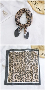 Detail showing flat-lay leopard print square scarf with high-quality chiffon texture