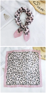 Detail of leopard print cotton linen square scarf with pink edges and stylish knotted look