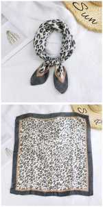 Detail of leopard print cotton linen square scarf showing flat layout and tied style