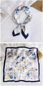 Floral silk-like scarf detail featuring navy blue edges and colorful pattern on white