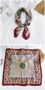 Detail of silk square scarf featuring geometric patterns in red, khaki, and green colors