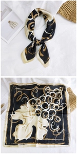 Detail view of square silk scarf with grapevine print in black, gold, and cream tones