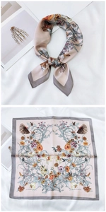 Detail of silk-like square scarf with floral and bird prints in beige and grey
