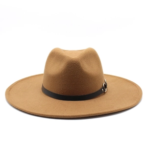 Close-up of camel wool fedora hat with a black leather band and silver buckle detail