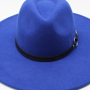 Detail of royal blue wool fedora hat featuring black band and triple metal ring buckle