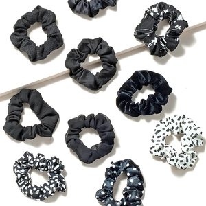 Set of 10 minimalist black and white fabric scrunchies in velvet and satin textures