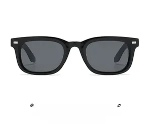 Detailed view of square black sunglasses featuring silver rivet accents on the frame edge