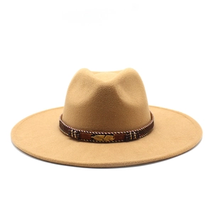 Detail of felt fedora hat featuring beaded band and golden feather metal buckle