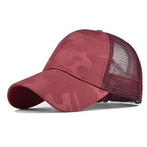 Close-up of ponytail baseball cap in burgundy camo with mesh back and adjustable hole