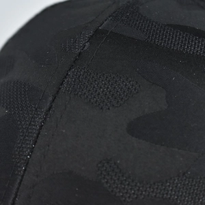 Detail of black camo ponytail baseball cap showing stitching and mesh fabric texture