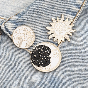 Three-piece sun moon and mountain enamel brooch set pinned on denim jacket