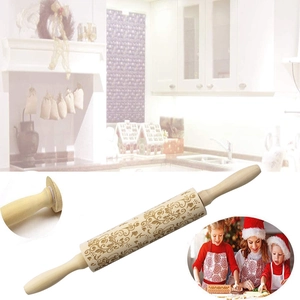 Macro detail of Christmas reindeer laser engraving on a wooden rolling pin surface