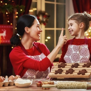 Close-up of wooden rolling pin with Christmas elk engraving in a warm family kitchen