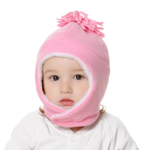 Close-up of pink fleece baby balaclava hat with ear protection and top tassel detail