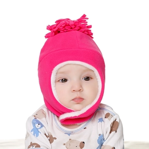 Detail of warm pink fleece baby winter hat with earflaps and white faux fur lining