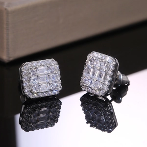 Macro detail of silver square stud earrings with pave-set zircon and tiered center stone