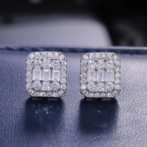 Elegant silver square baguette-cut zircon stud earrings on dark leather background