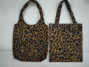 Flat lay of leopard print tote and handbag showing textured corduroy fabric detail