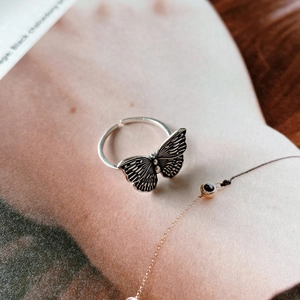 Detailed view of a vintage 925 sterling silver butterfly ring with an adjustable open band