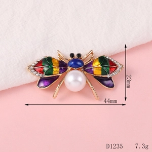 Detail view of colorful bee alloy accessory with rhinestones and dimensions 44mm x 23mm