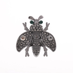Vintage style bee brooch in dark grey metal with sparkling crystals and green gem eyes