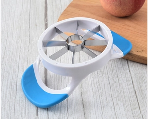 Macro detail of stainless steel apple slicer blades with blue ergonomic handles on wood