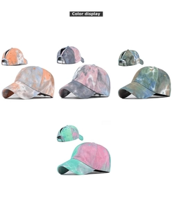 Detail view of tie-dye cotton baseball caps with a ponytail hole in four vibrant colors