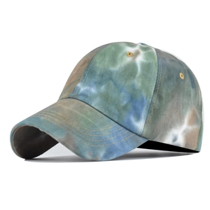 Macro detail of tie-dye cotton sun hat showing vintage texture and precise stitching