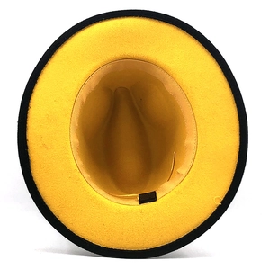 Detail view of two-tone wool felt fedora showing yellow interior and black sweatband
