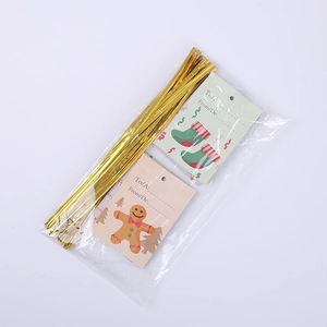 Detail of gold twist ties and festive Christmas tags with gingerbread man and stockings