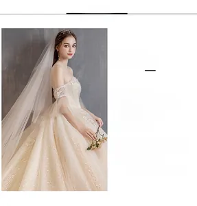 Detailed close-up of champagne lace bridal gown with off-shoulder sleeves and sequins