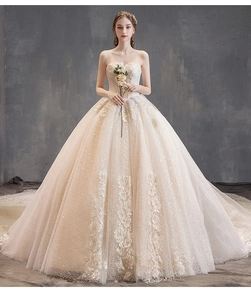 Detail of champagne bridal gown featuring exquisite 3D floral lace and sequin embroidery