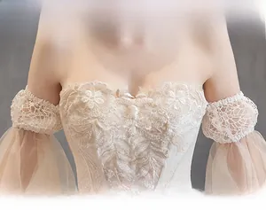 Detailed embroidery and sequins on champagne off-shoulder wedding dress with puff sleeves