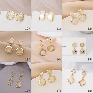 Selection of gold cat eye stone earrings with geometric and floral designs numbered 10-18