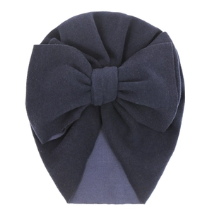 Detail of dark purple baby turban hat with a large double bow made of soft knit fabric