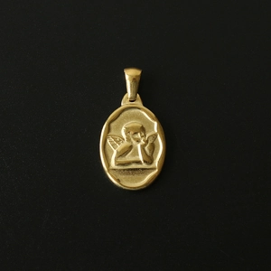 Macro shot of 18K gold-plated oval pendant featuring an embossed vintage cherub angel design