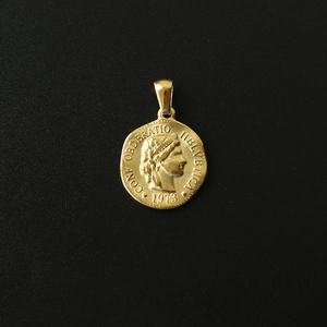 Detailed macro view of 18K gold plated coin pendant with 1973 Swiss portrait engraving