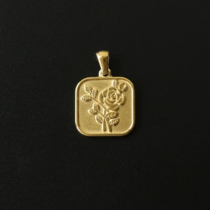 Detailed close-up of 18K gold-plated square pendant featuring a 3D rose flower relief