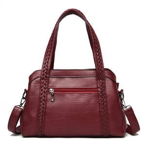 Classic wine red PU leather handbag for women featuring unique woven handles and soft texture
